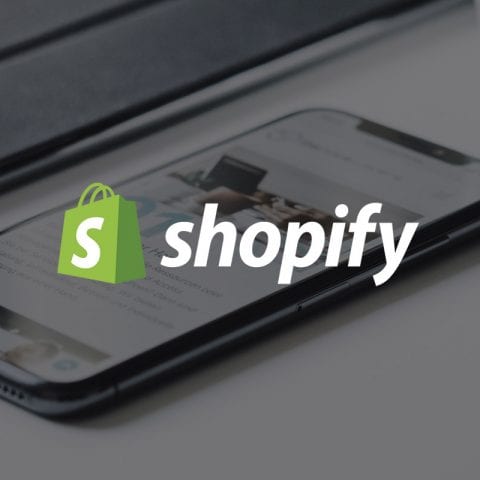 Shopify logo with smartphone in background