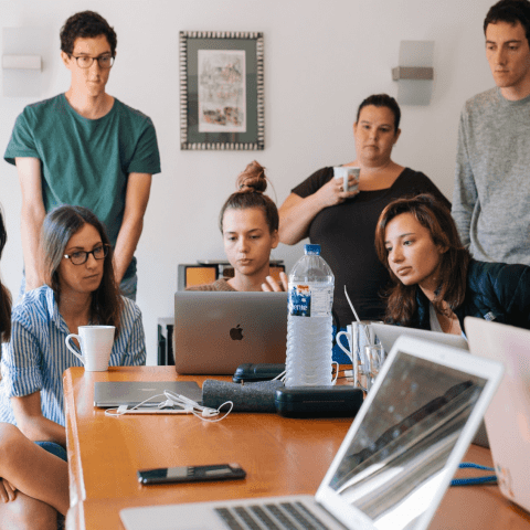 People crowded around desk
